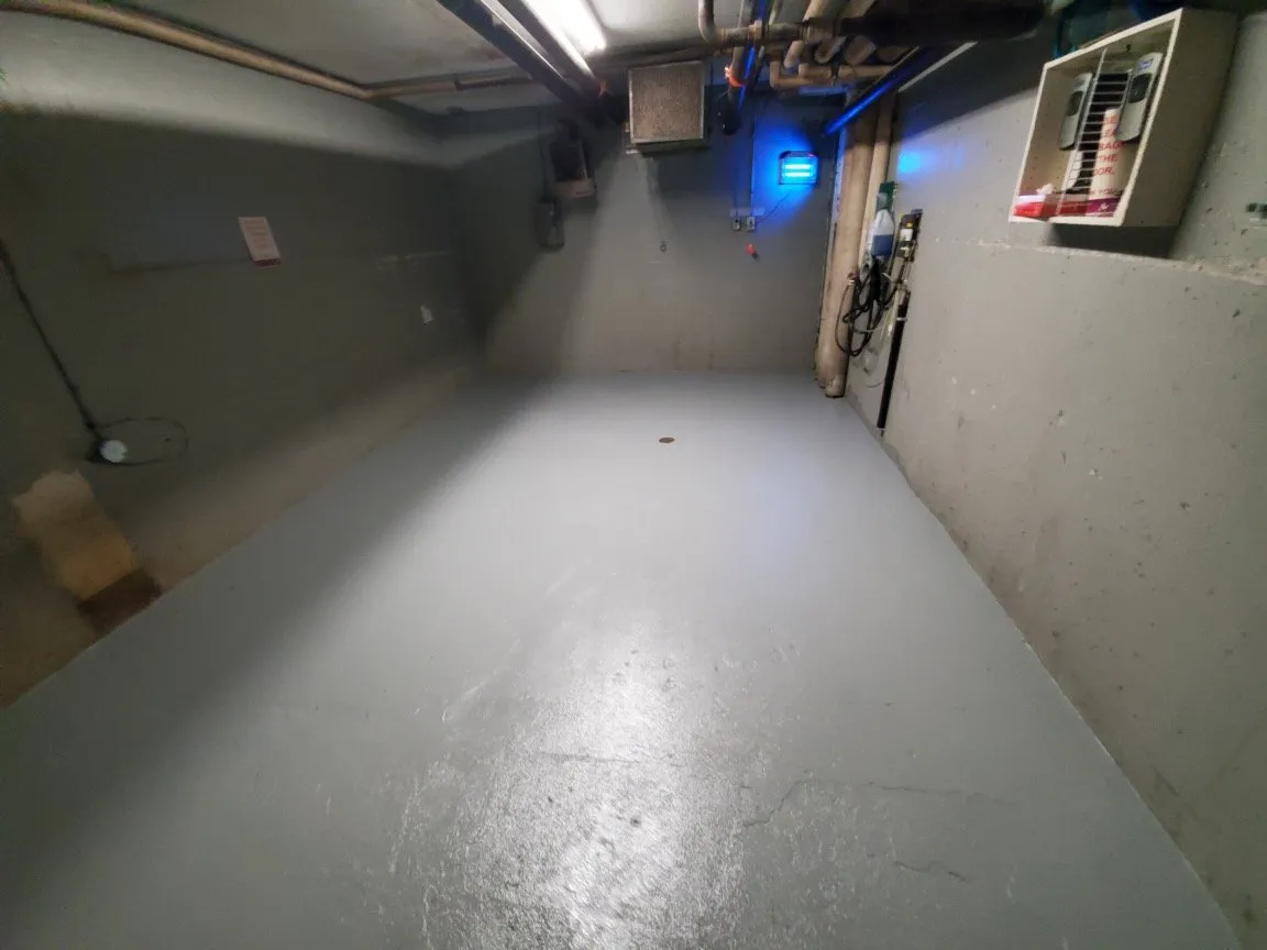 The same garbage room after WasteMind's epoxy floor retrofit, sealed and clean